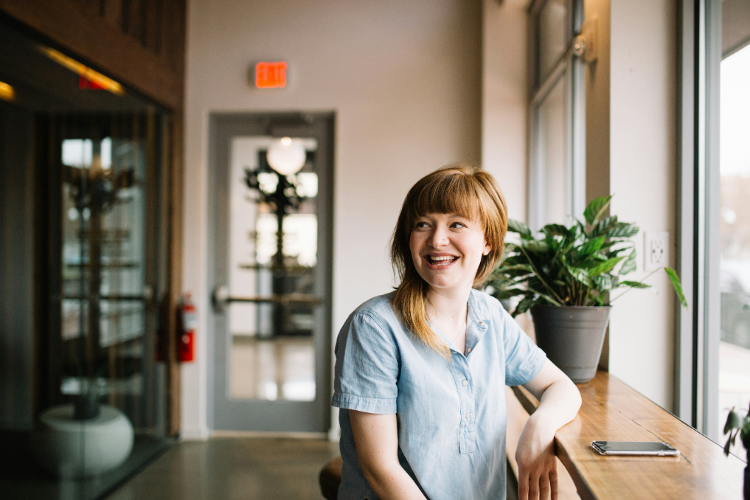 Person laughing, representing confidence and positive experience with Conjoint and MaxDiff analysis services