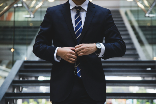 hunters-race-MYbhN8KaaEc-unsplash (1) Man adjusting his tie in a tuxedo representing professionalism and confidence at NitiGlobal