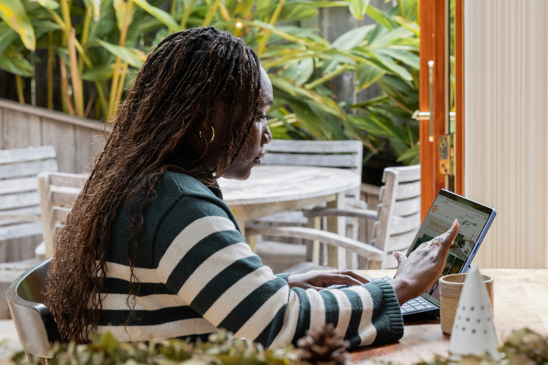 Woman working on laptop representing professional expertise and reliable service